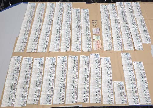 Cash seized from the three Chinese nationals during their arrest.