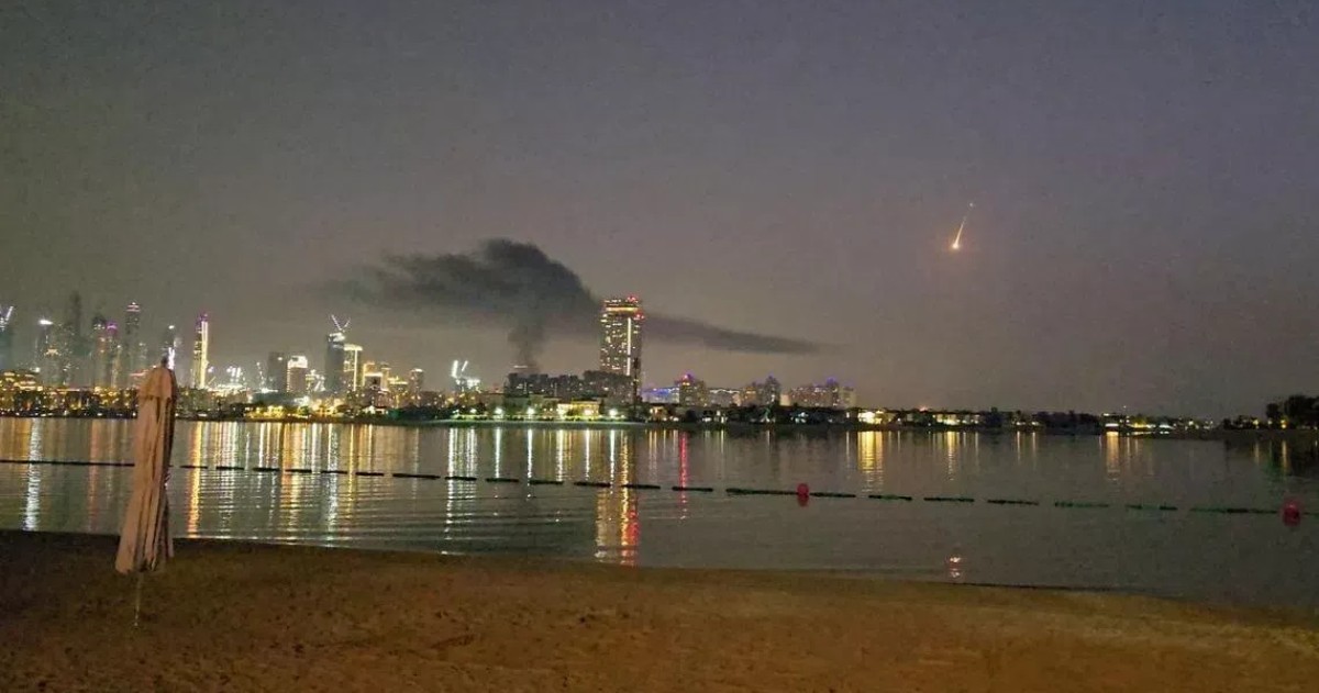 Smoke rises over a hotel damaged in Dubai's famed Palm Jumeirah.